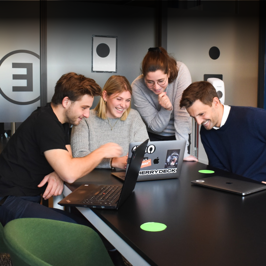 GenTwo colleagues gathered around a laptop, collaborating